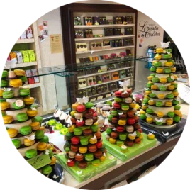 Une superbe pyramide de macarons multicolores, présentée de manière artistique, parfaite pour un événement raffiné.